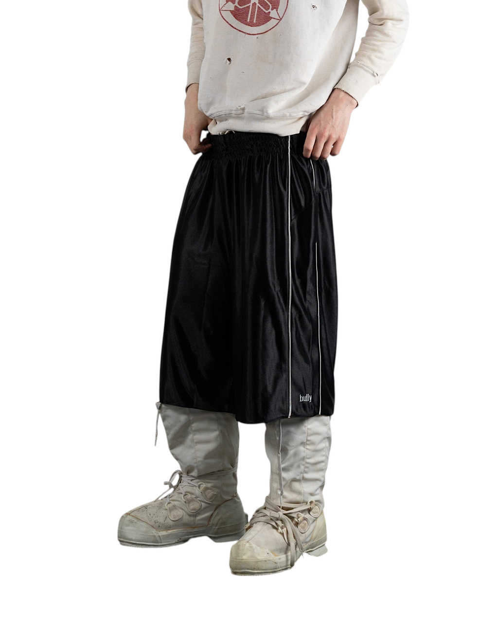 BULLY LA black raschel knit polyester shorts with silver contrast piping and embroidered logo, worn by a male model.