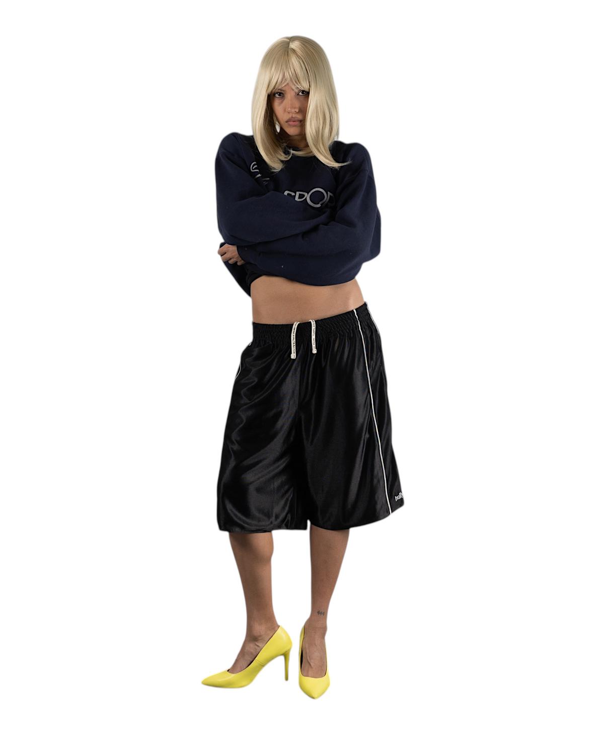 BULLY LA black reversible raschel knit shorts with silver piping and screen printed drawcords worn by a model