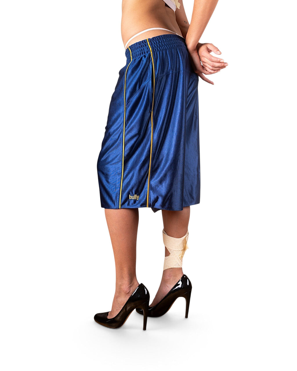 BULLY LA navy raschel knit polyester shorts with yellow contrast piping and yellow BULLY embroidery on a model