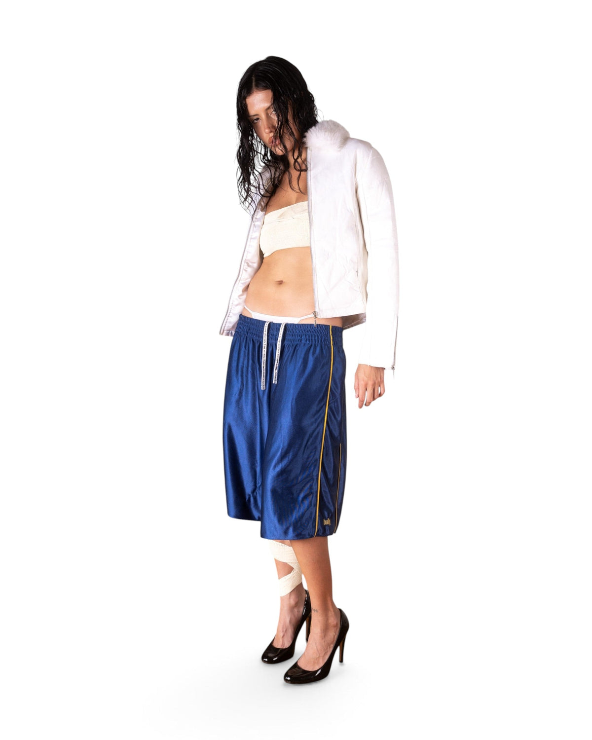 BULLY LA navy raschel knit polyester shorts with yellow piping and embroidery worn by a model in a studio setting
