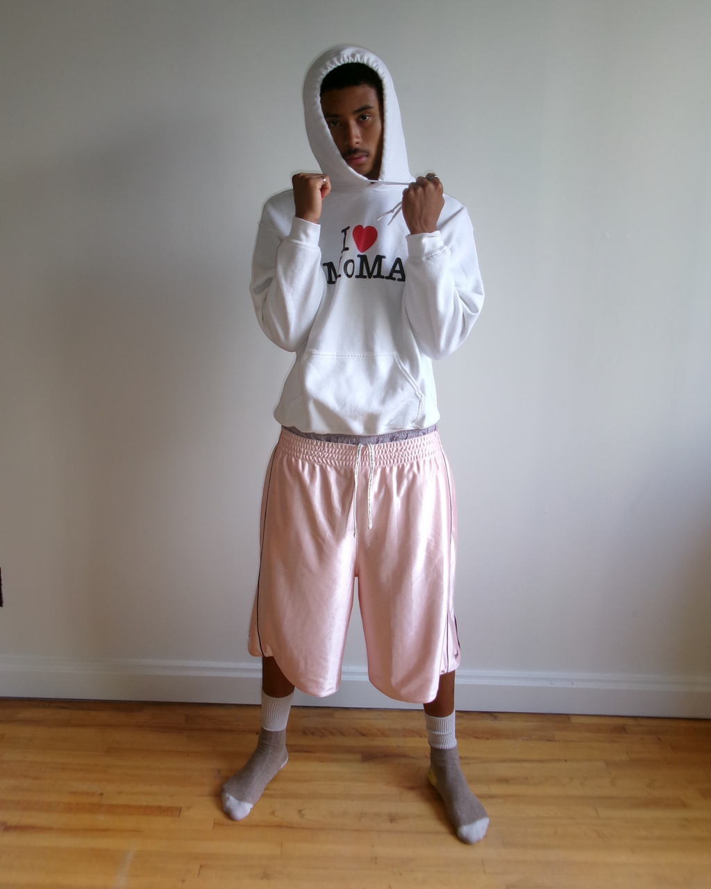 BULLY LA pink raschel knit polyester shorts with chocolate brown piping and side pockets worn by a male model