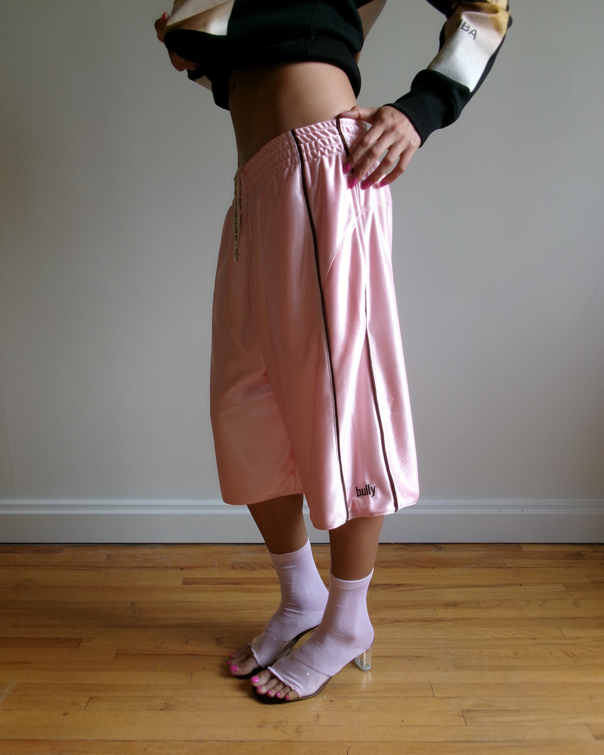 BULLY LA pink raschel knit polyester shorts with chocolate brown piping and embroidered logo, worn by a model.